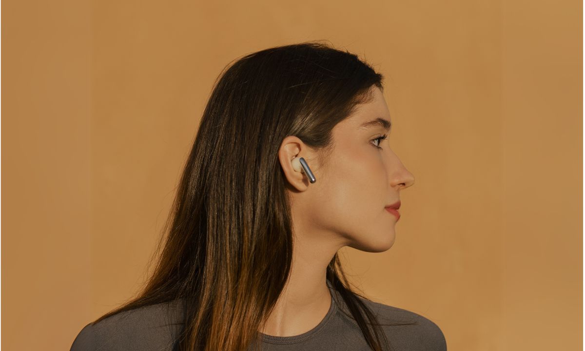 A woman wearing earbuds
